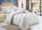 A six piece comforter set with a floral pattern displayed on a double bed, including a comforter, bedsheets, pillow covers, and cushion covers.